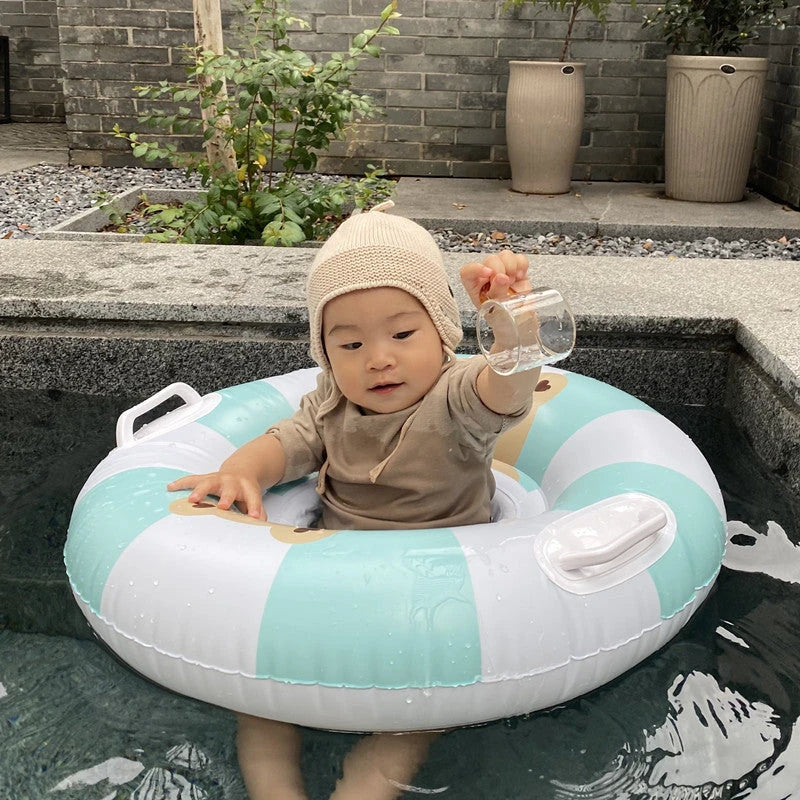 A green inflatable swim ring with a cotton pocket seat, designed for safe and enjoyable water play for children aged 1-5 years.