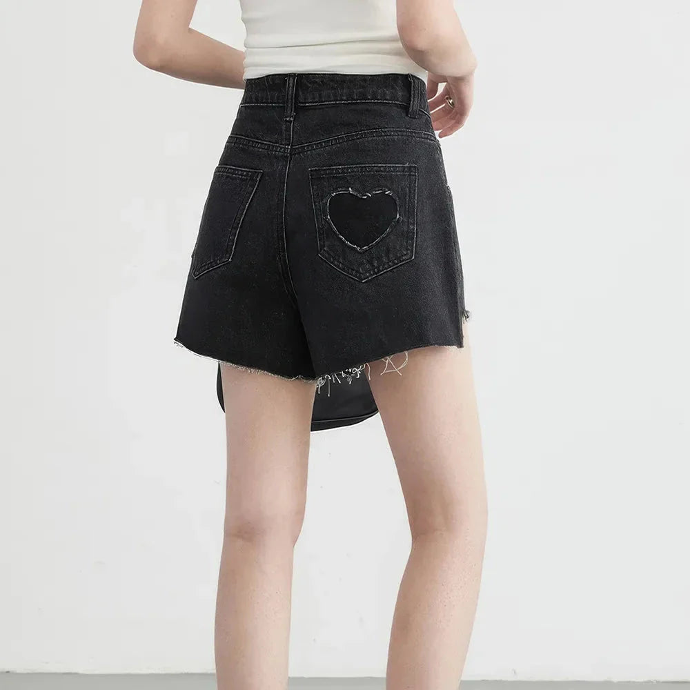 Women's high-waisted denim shorts with asymmetric hemline in black colour