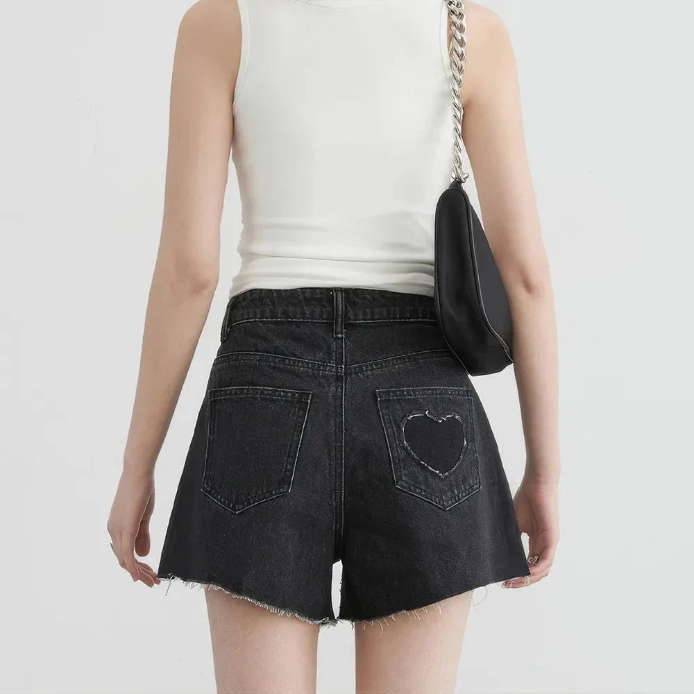 Women's high-waisted denim shorts with asymmetric hemline in black colour