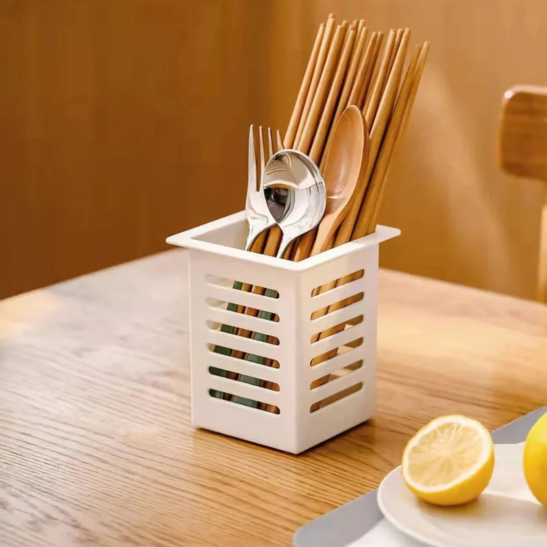 A white, wall-mounted toothbrush and cosmetic holder with a suction cup for easy installation