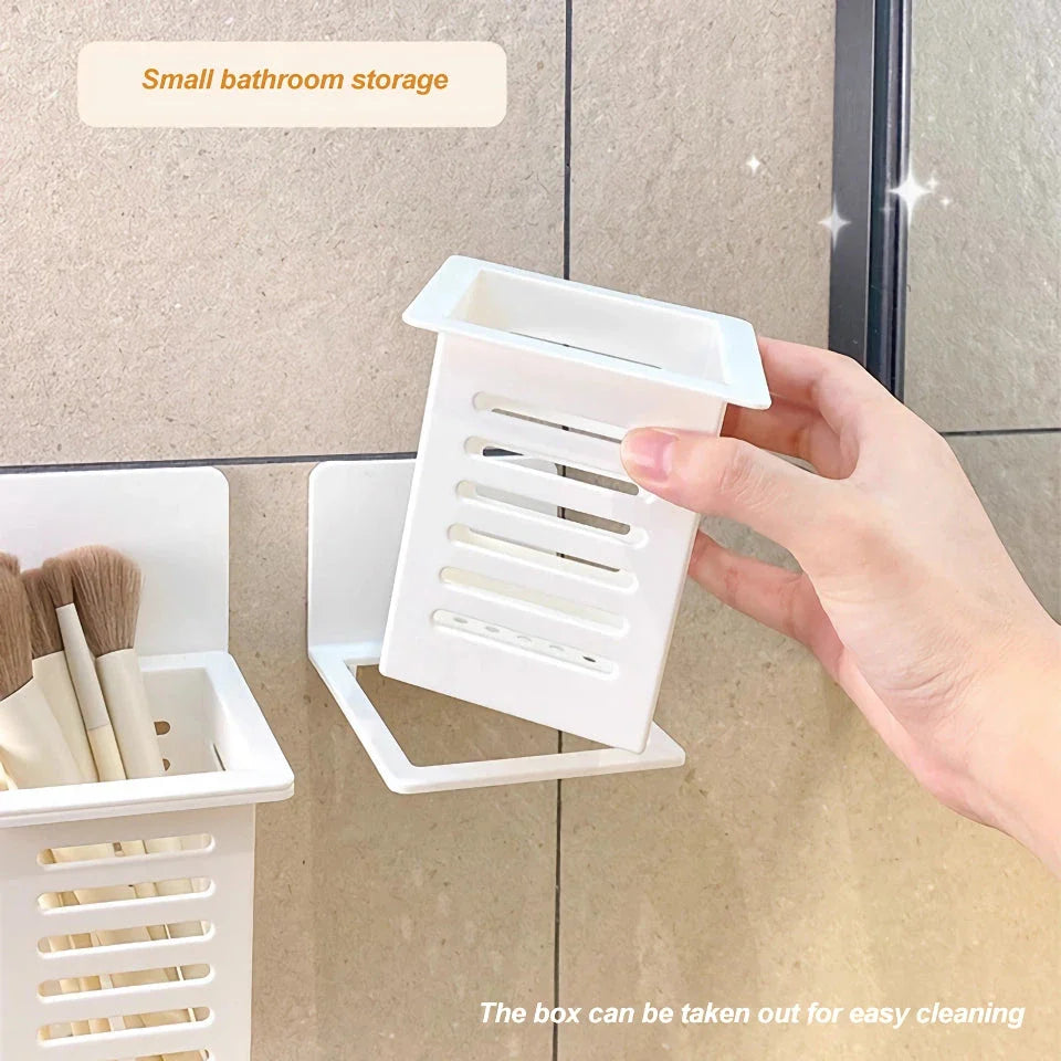 A white, wall-mounted toothbrush and cosmetic holder with a suction cup for easy installation