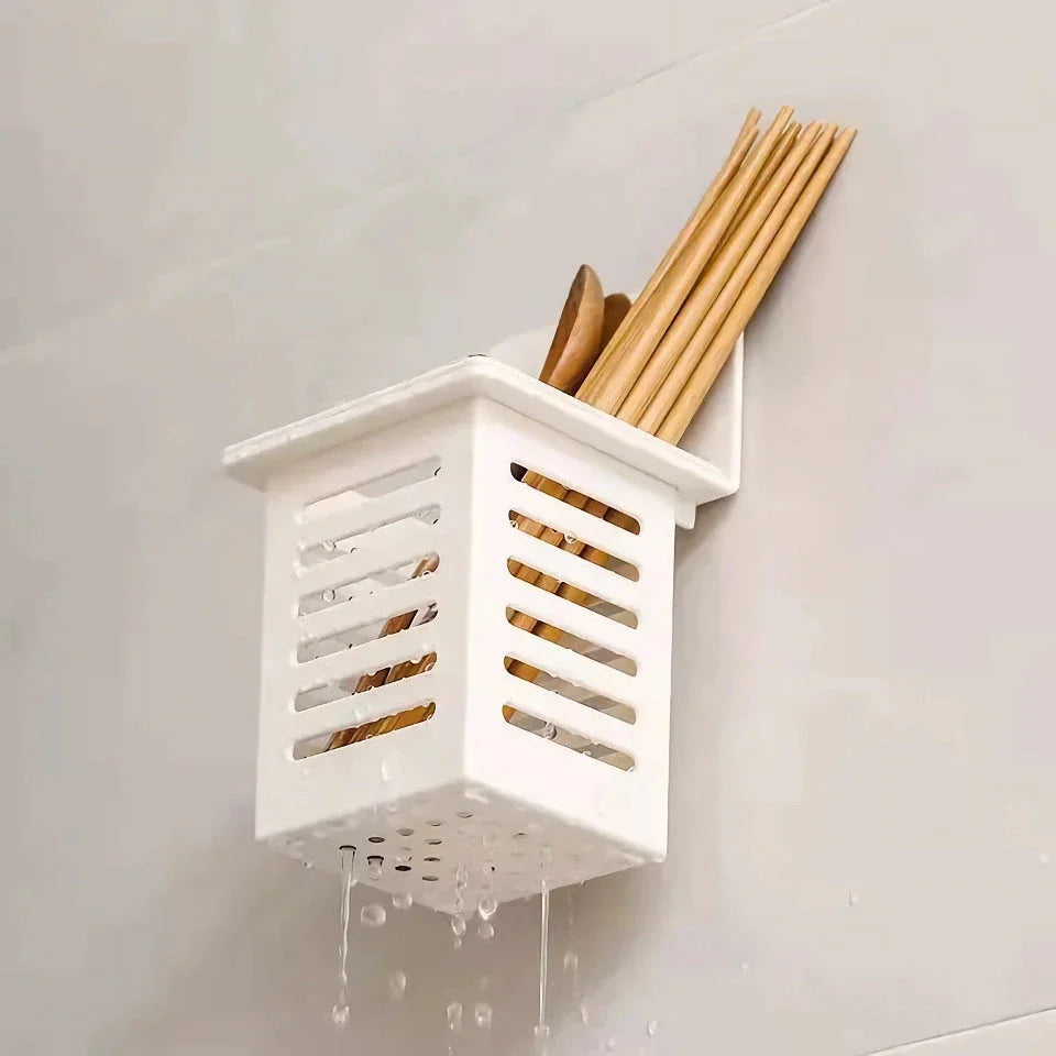 A white, wall-mounted toothbrush and cosmetic holder with a suction cup for easy installation