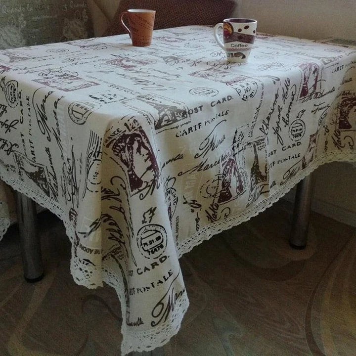 A decorative Paris-themed cotton and linen tablecloth featuring iconic landmarks and a romantic French design