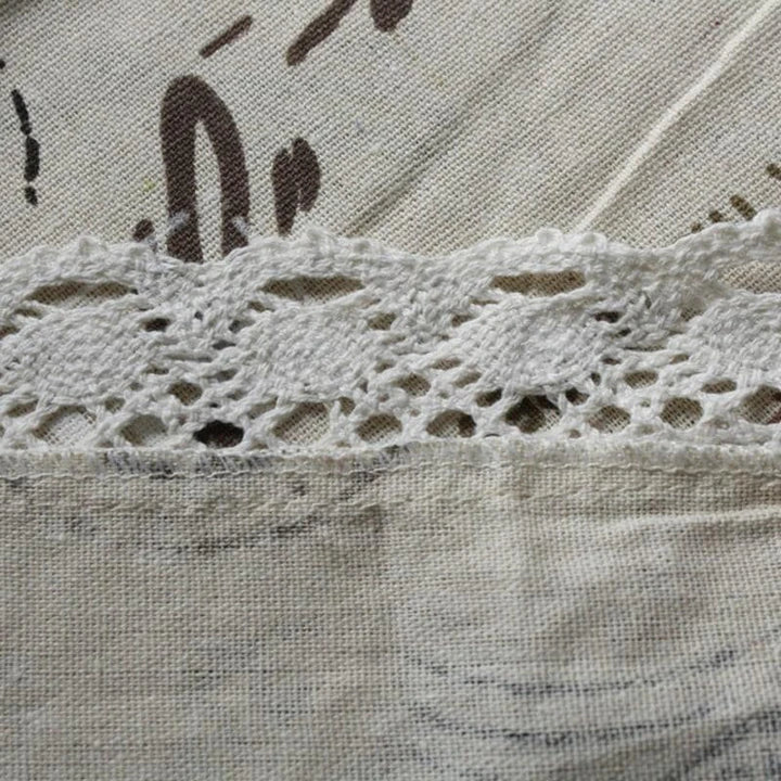 A decorative Paris-themed cotton and linen tablecloth featuring iconic landmarks and a romantic French design