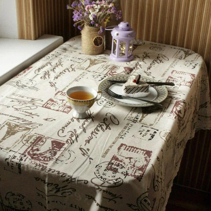 A decorative Paris-themed cotton and linen tablecloth featuring iconic landmarks and a romantic French design