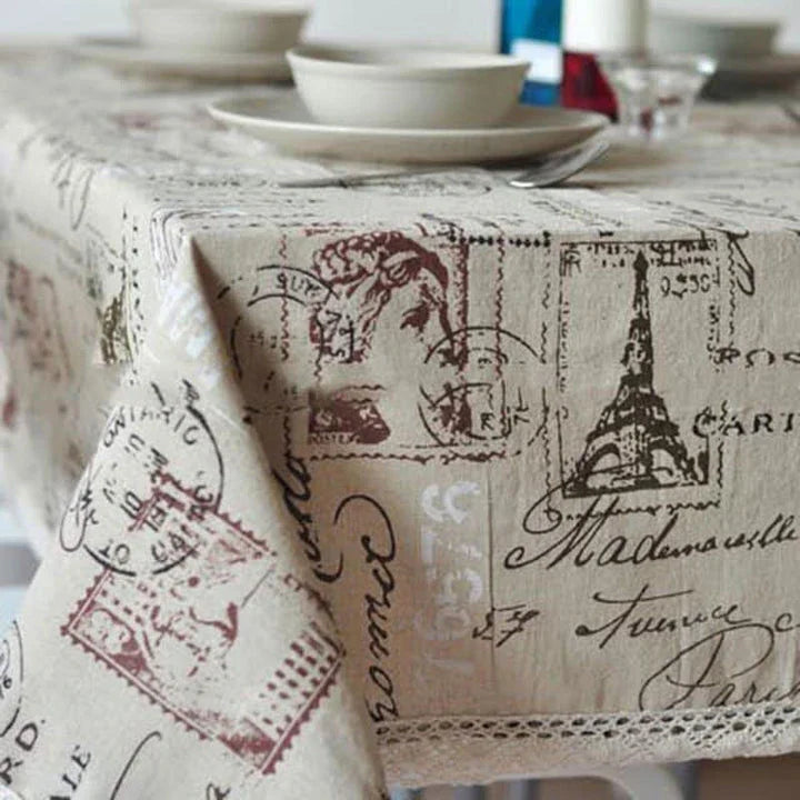 A decorative Paris-themed cotton and linen tablecloth featuring iconic landmarks and a romantic French design