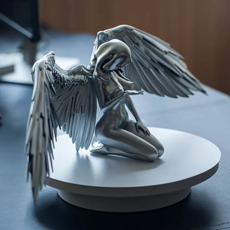 Elegant silver angel wings resin ornament with intricate feather detailing and a warm, ambient glow