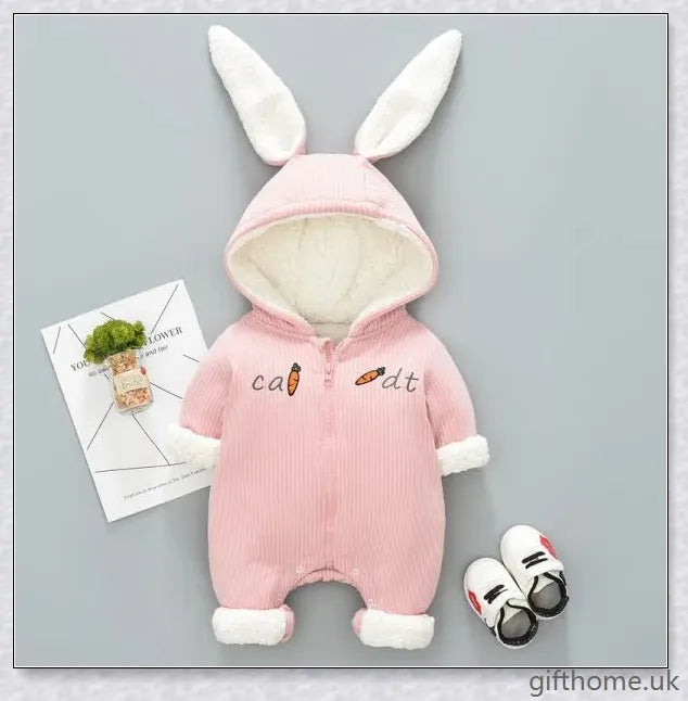 Adorable baby wearing a cosy, hooded rabbit-themed jumpsuit in light blue