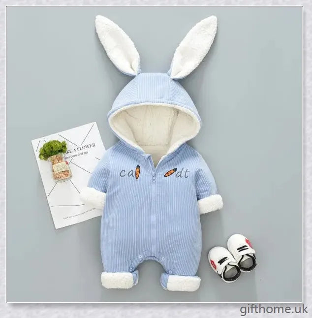 Adorable baby wearing a cosy, hooded rabbit-themed jumpsuit in light blue