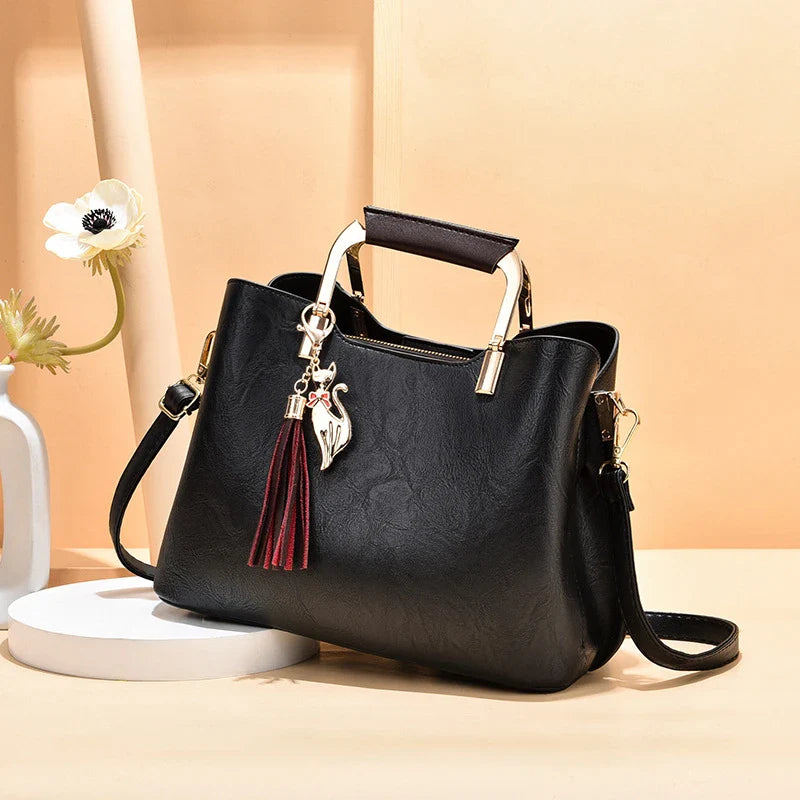 Stylish and versatile ladies handbag in black, featuring a horizontal square design with multiple interior compartments for optimal organisation.