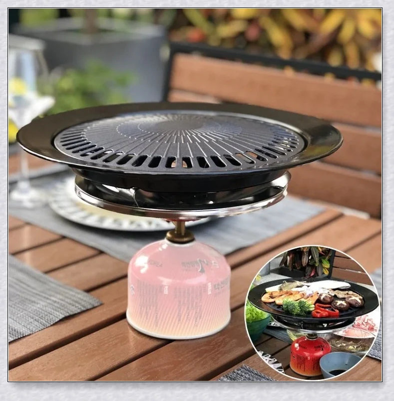 Hunters Creek Portable Korean Outdoor Barbecue Gas Grill Pan with various cooking accessories, including a baking tray, kettle, and pot