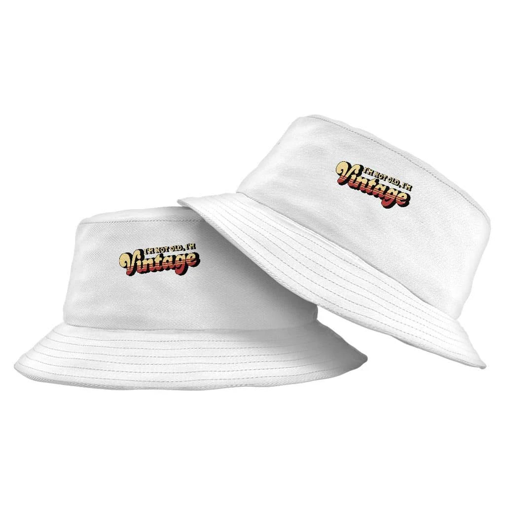 A vintage-inspired graphic bucket hat with a 'I'm Not Old I'm Vintage' design, made from high-quality materials for outdoor activities and casual wear.