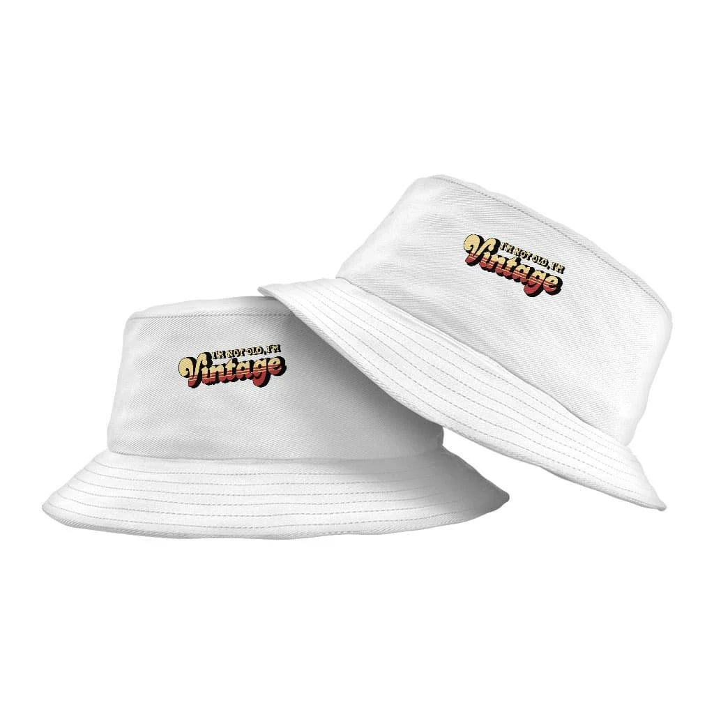 A vintage-inspired graphic bucket hat with a 'I'm Not Old I'm Vintage' design, made from high-quality materials for outdoor activities and casual wear.