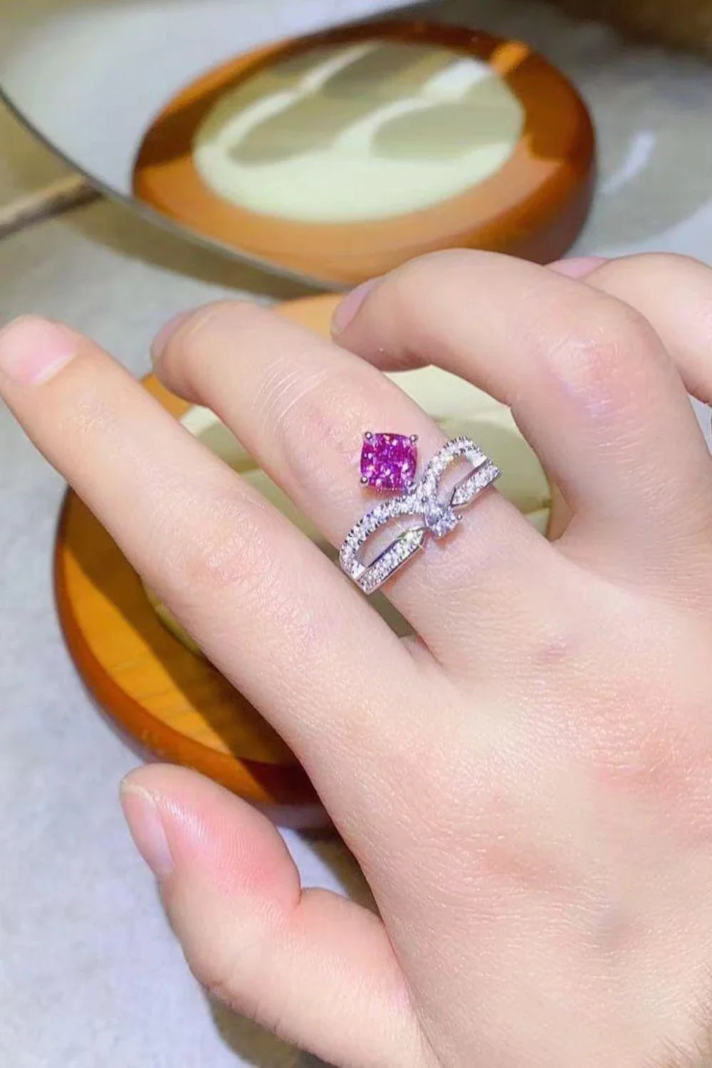 Elegant 1 carat moissanite ring in fuchsia pink, featuring a minimalist design and a lustrous platinum-plated finish