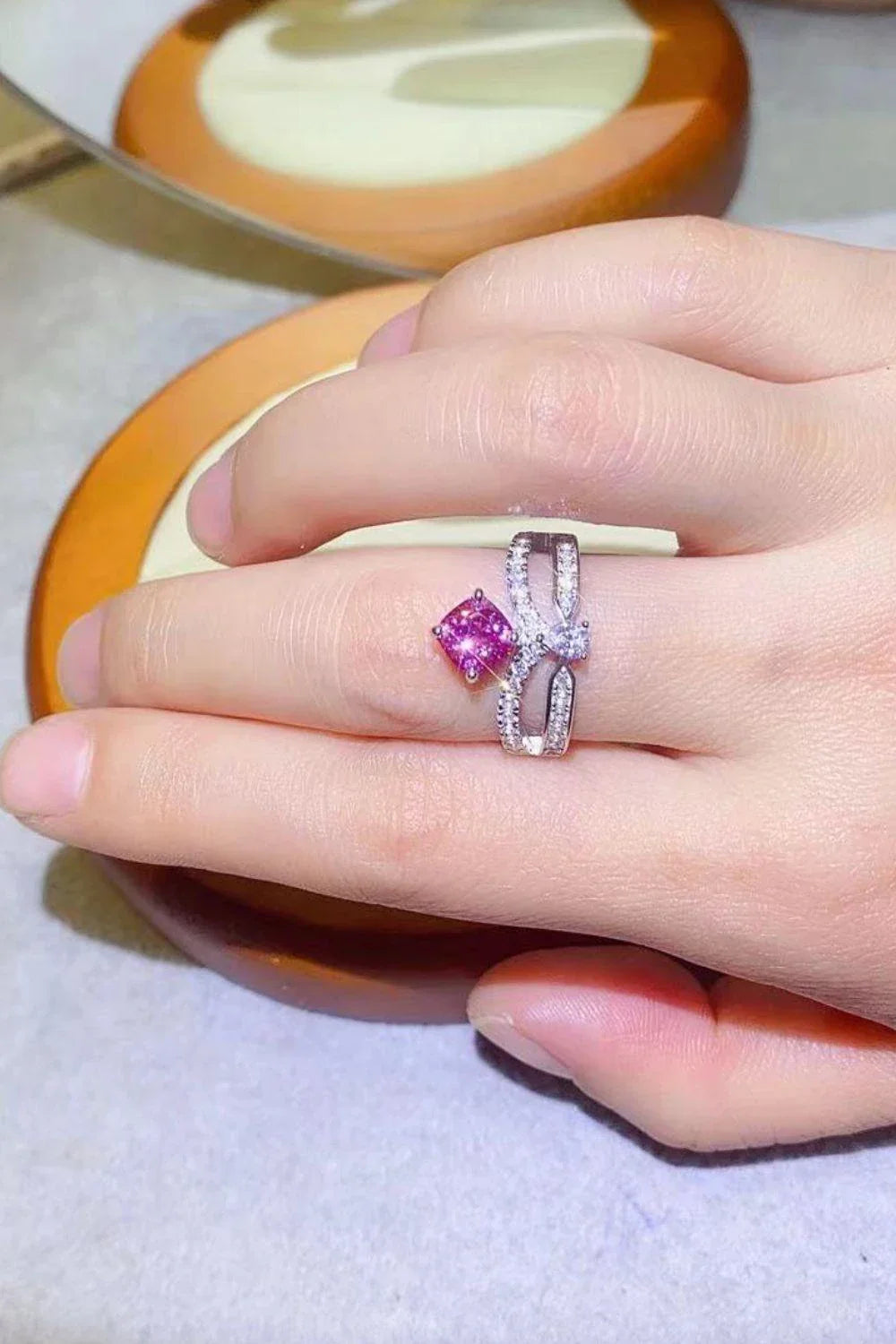 Elegant 1 carat moissanite ring in fuchsia pink, featuring a minimalist design and a lustrous platinum-plated finish