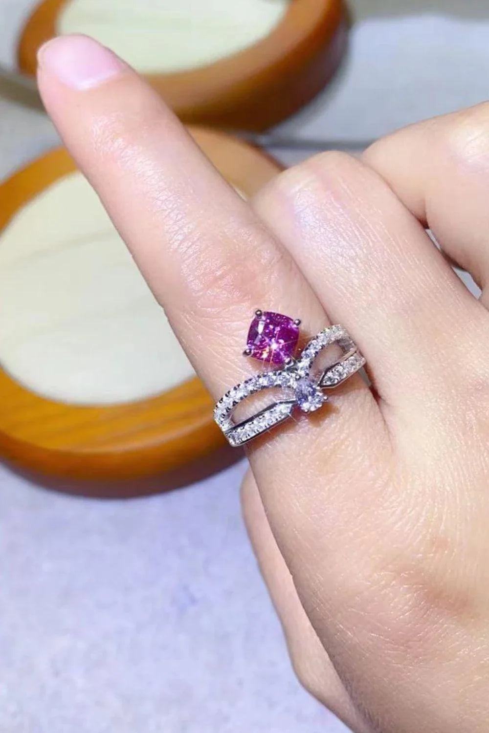 Elegant 1 carat moissanite ring in fuchsia pink, featuring a minimalist design and a lustrous platinum-plated finish
