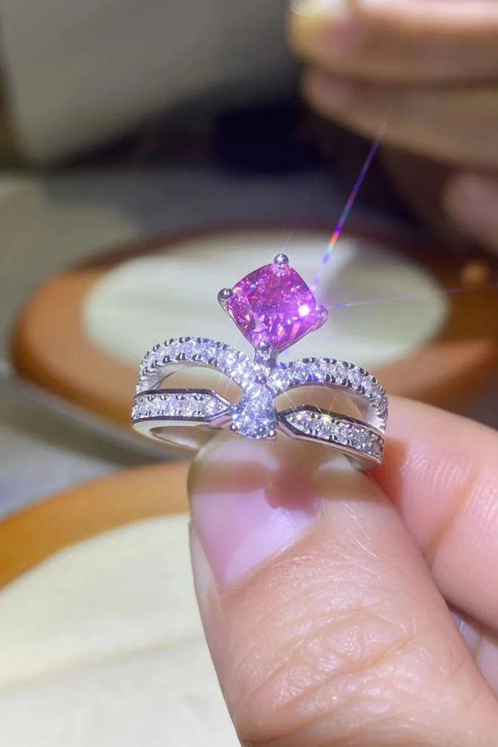 Elegant 1 carat moissanite ring in fuchsia pink, featuring a minimalist design and a lustrous platinum-plated finish
