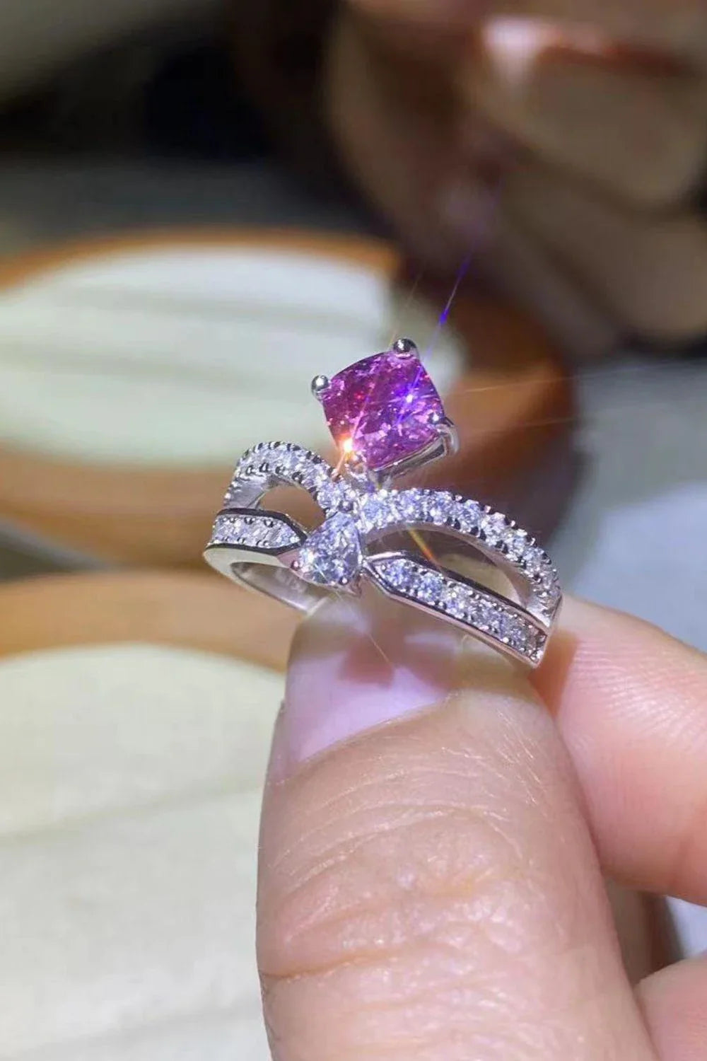 Elegant 1 carat moissanite ring in fuchsia pink, featuring a minimalist design and a lustrous platinum-plated finish