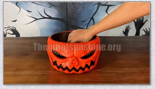 Pumpkin-shaped candy bowl with a creepy moving skeleton hand that jumps out to startle guests, ideal for Halloween decorations and parties.