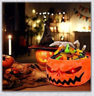 Pumpkin-shaped candy bowl with a creepy moving skeleton hand that jumps out to startle guests, ideal for Halloween decorations and parties.