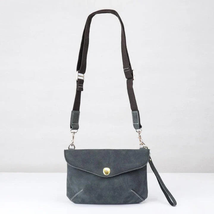 A vintage-inspired brown leather messenger bag with an adjustable strap and multiple interior compartments for organisation and storage.