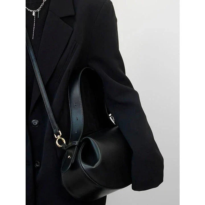 Elegant round vegan leather handbag with a distinctive circular shape, durable construction, and spacious interior organisation