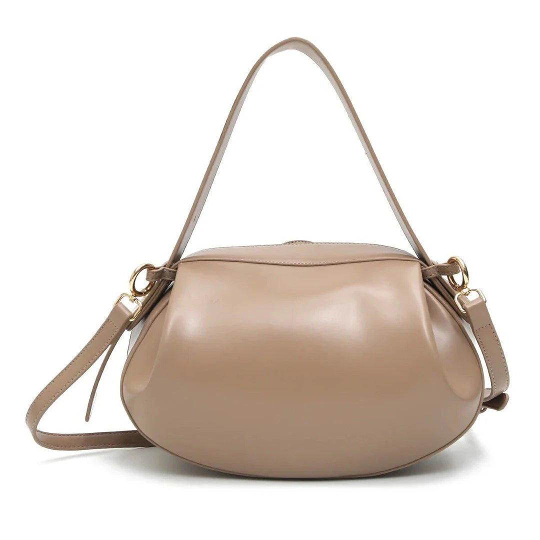 Elegant round vegan leather handbag with a distinctive circular shape, durable construction, and spacious interior organisation
