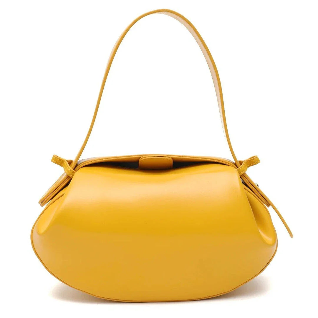 Elegant round vegan leather handbag with a distinctive circular shape, durable construction, and spacious interior organisation