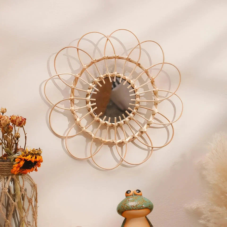 Handmade rattan decorative wall mirror with a flower-shaped design, adding natural charm and elegance to a living space.