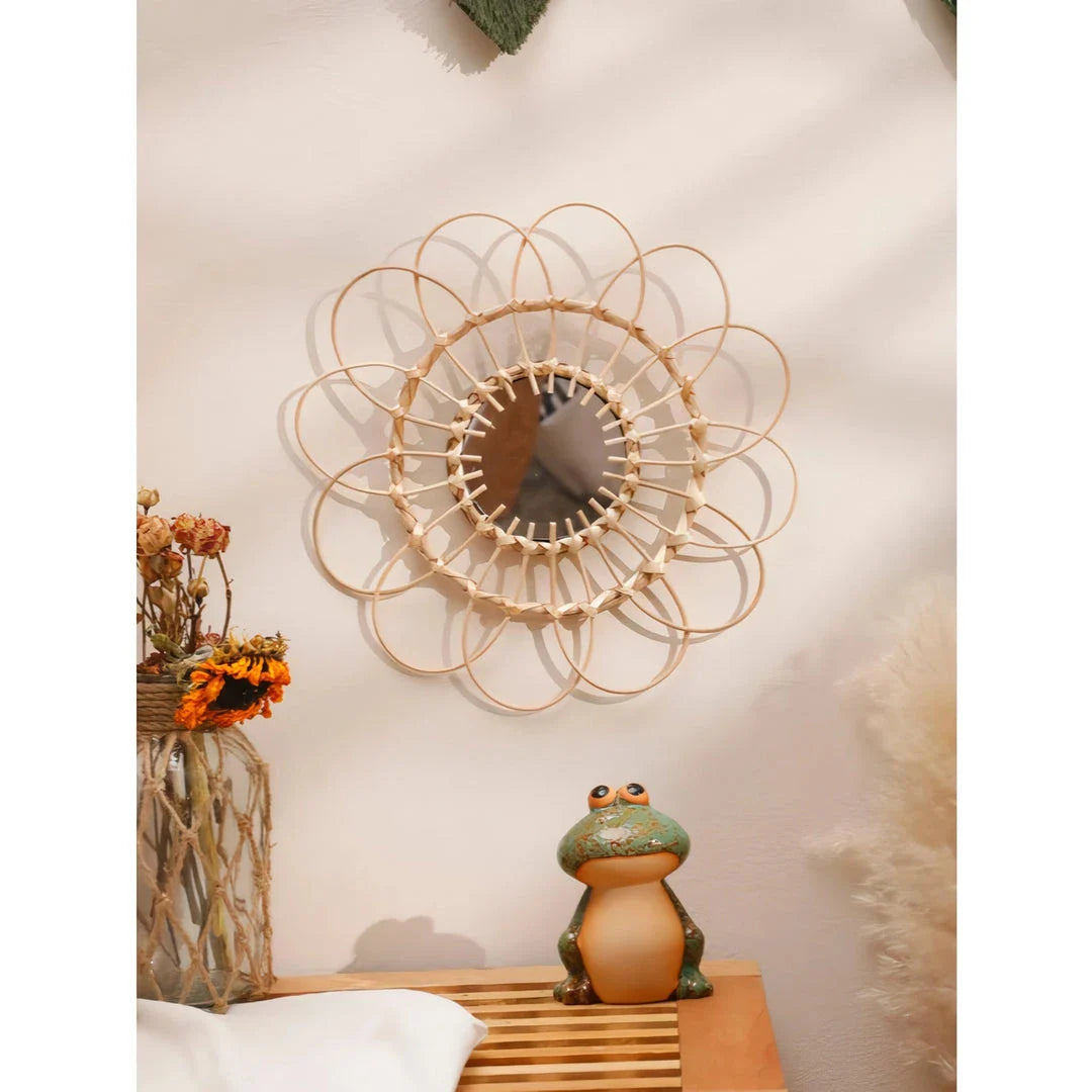 Handmade rattan decorative wall mirror with a flower-shaped design, adding natural charm and elegance to a living space.