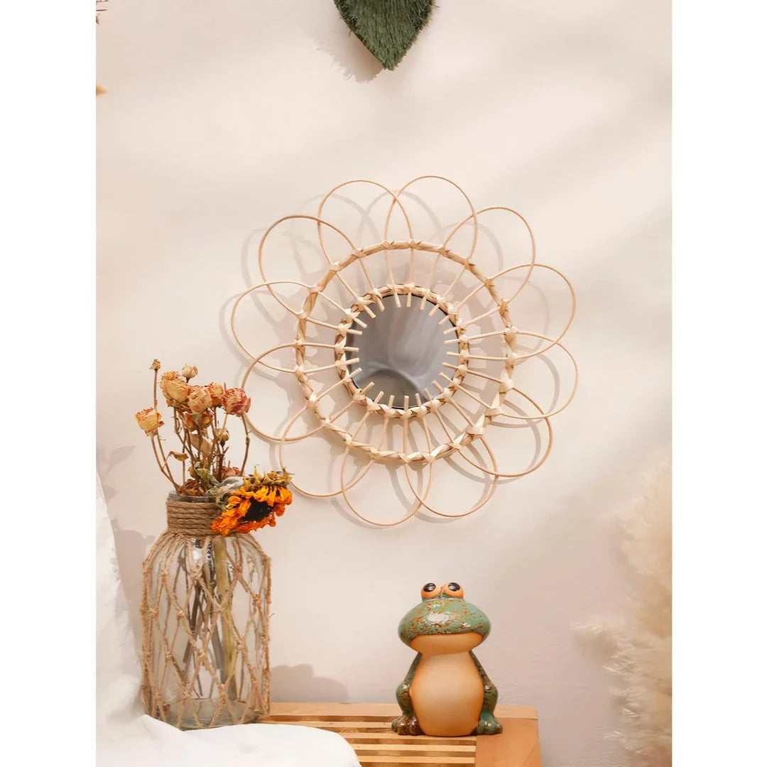 Handmade rattan decorative wall mirror with a flower-shaped design, adding natural charm and elegance to a living space.