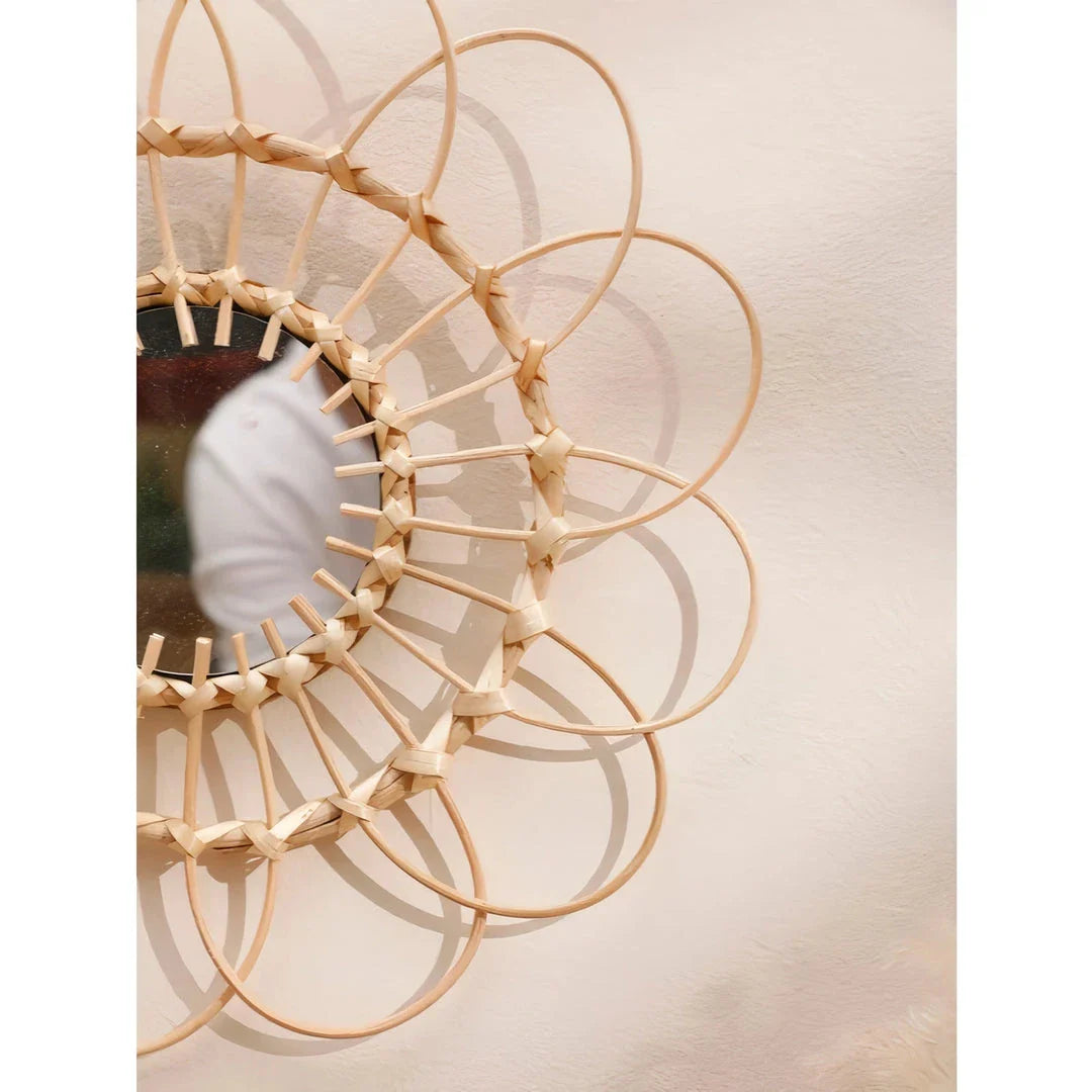 Handmade rattan decorative wall mirror with a flower-shaped design, adding natural charm and elegance to a living space.