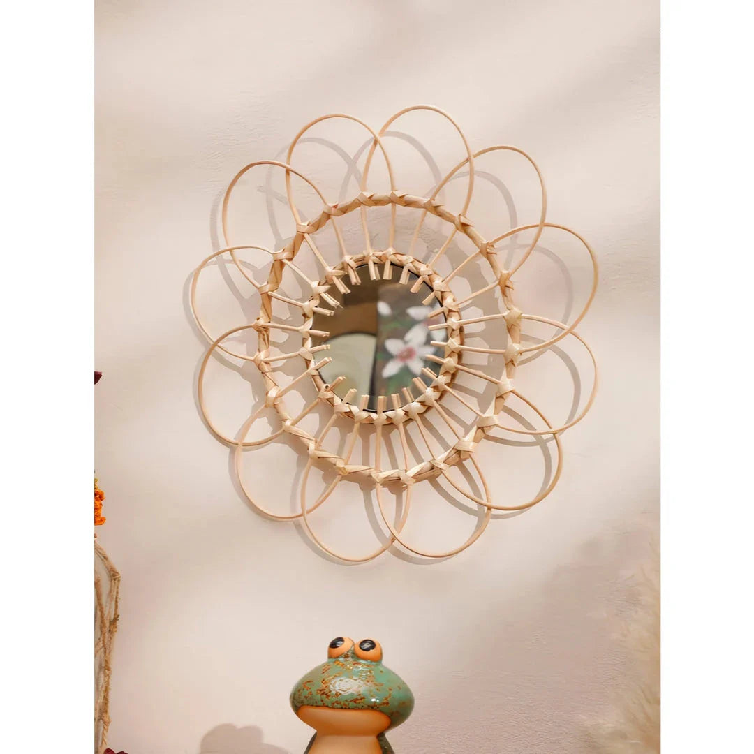 Handmade rattan decorative wall mirror with a flower-shaped design, adding natural charm and elegance to a living space.