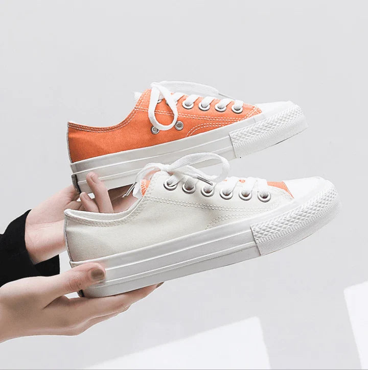 Pair of colour-changing canvas shoes with a white upper and a flat, rubber sole