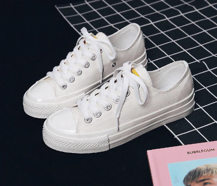 Pair of colour-changing canvas shoes with a white upper and a flat, rubber sole