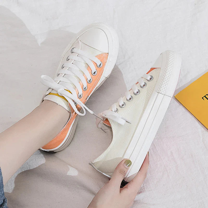 Pair of colour-changing canvas shoes with a white upper and a flat, rubber sole