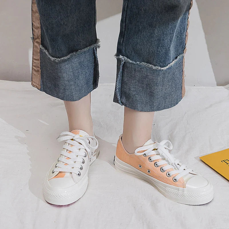 Pair of colour-changing canvas shoes with a white upper and a flat, rubber sole