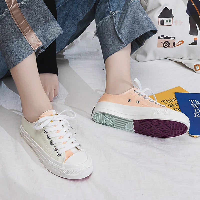 Pair of colour-changing canvas shoes with a white upper and a flat, rubber sole