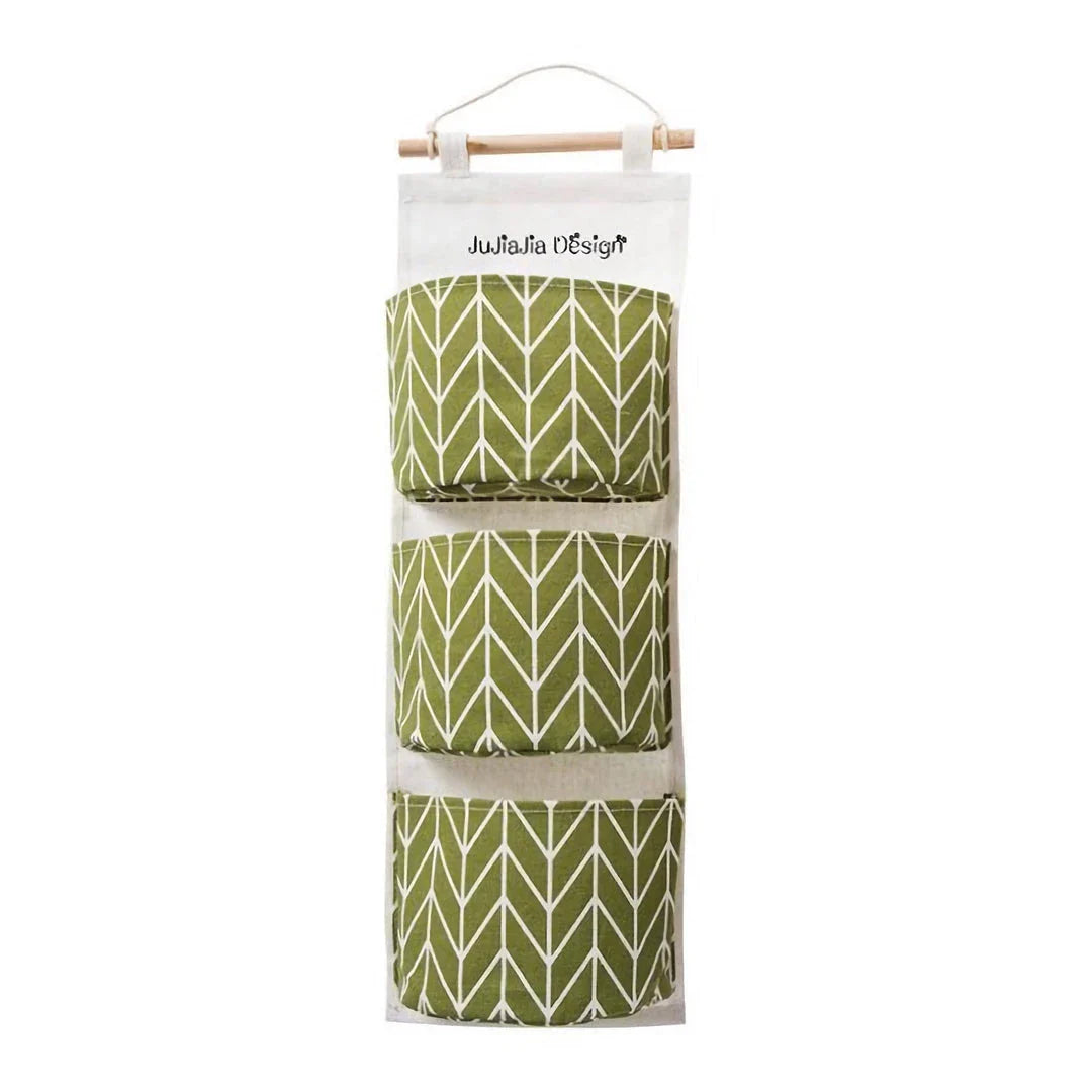 A green hanging storage bag with three compartments, designed to neatly organise everyday items in the home.