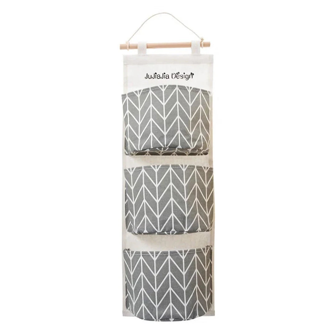 A green hanging storage bag with three compartments, designed to neatly organise everyday items in the home.