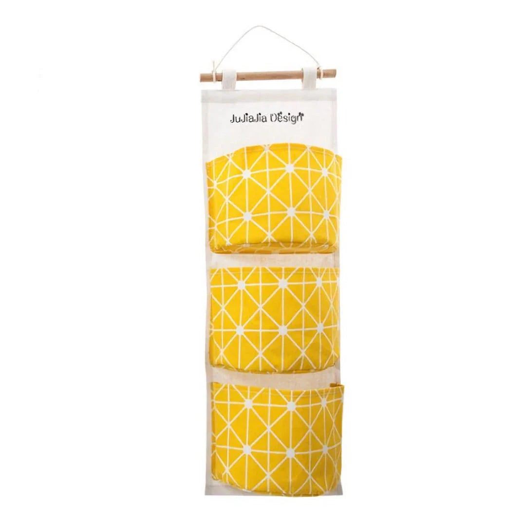 A green hanging storage bag with three compartments, designed to neatly organise everyday items in the home.