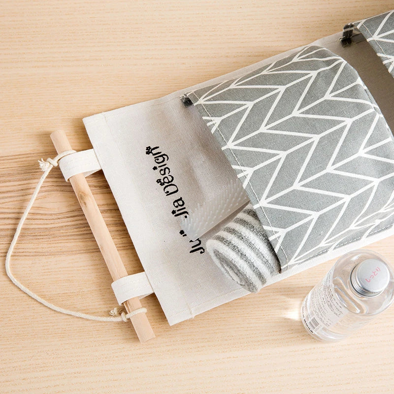 A green hanging storage bag with three compartments, designed to neatly organise everyday items in the home.