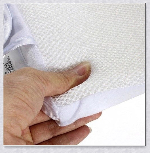 Newborn baby sleep pillow with fixed position and anti-roll support, designed for comfort and breathability