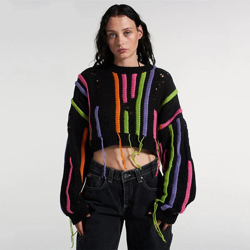 A chic knitted pullover with tassels and a patchwork design, perfect for autumn and winter fashion.