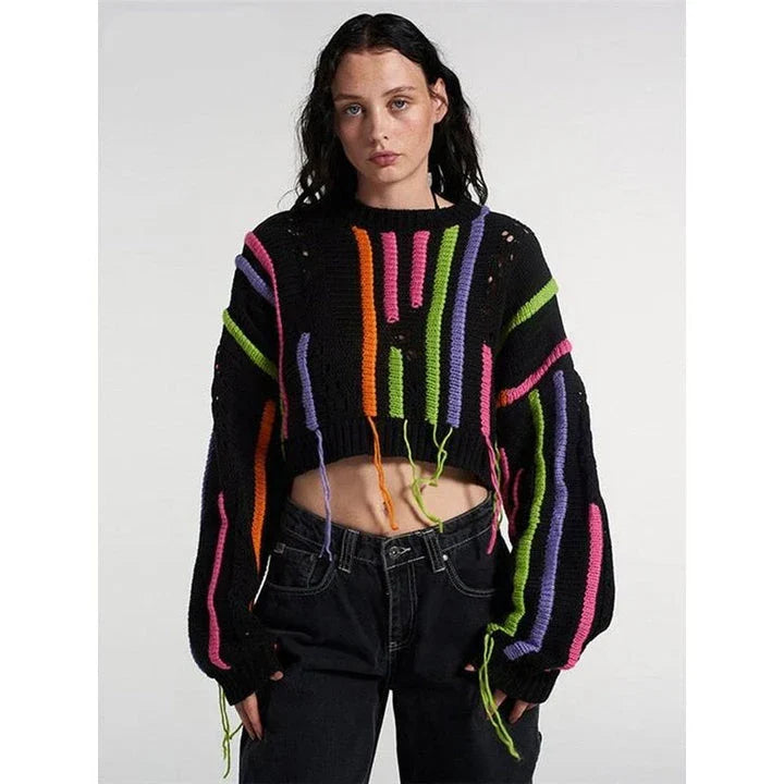 A chic knitted pullover with tassels and a patchwork design, perfect for autumn and winter fashion.