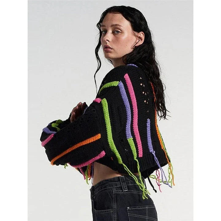 A chic knitted pullover with tassels and a patchwork design, perfect for autumn and winter fashion.