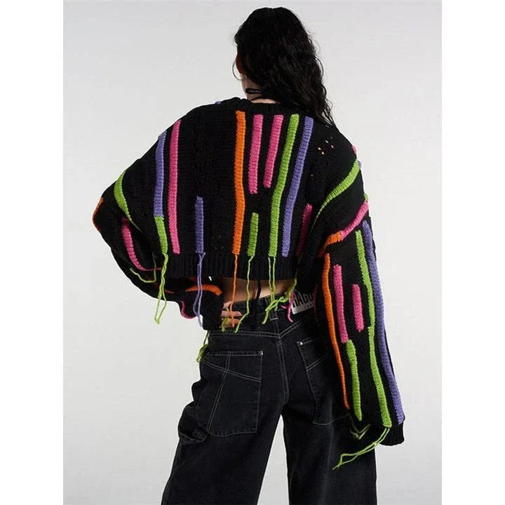 A chic knitted pullover with tassels and a patchwork design, perfect for autumn and winter fashion.