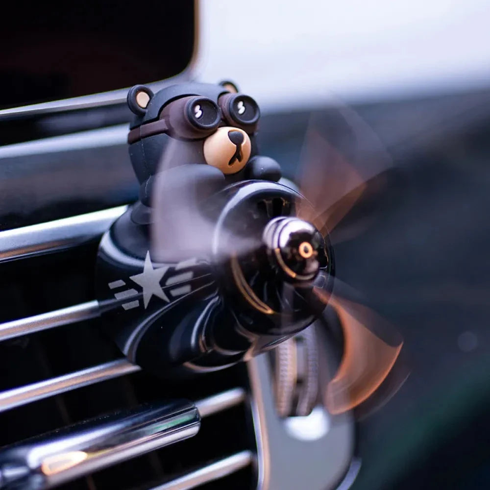Bear Pilot Car Air Freshener with spinning propeller, diffusing a calming ocean fragrance in a vehicle