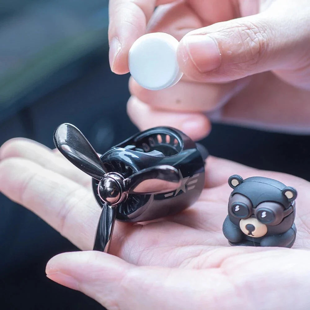 Bear Pilot Car Air Freshener with spinning propeller, diffusing a calming ocean fragrance in a vehicle