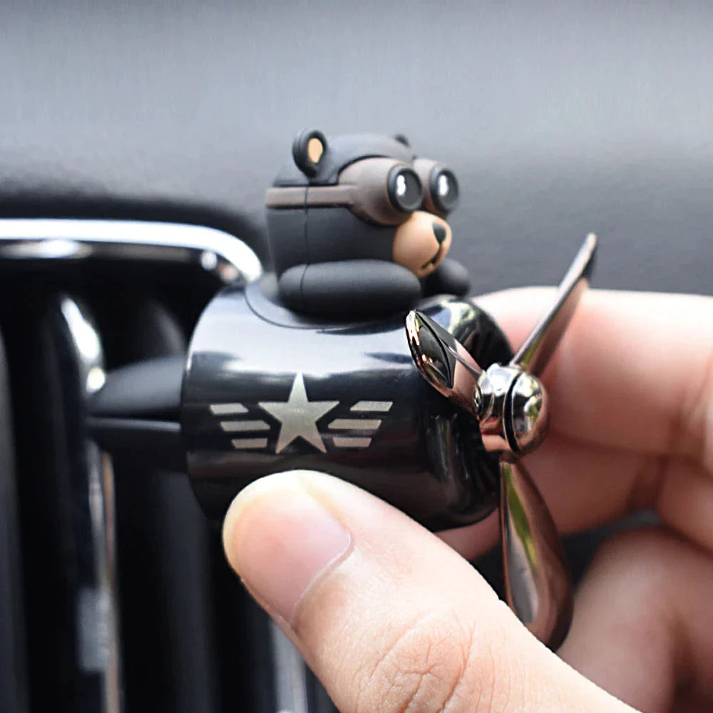 Bear Pilot Car Air Freshener with spinning propeller, diffusing a calming ocean fragrance in a vehicle